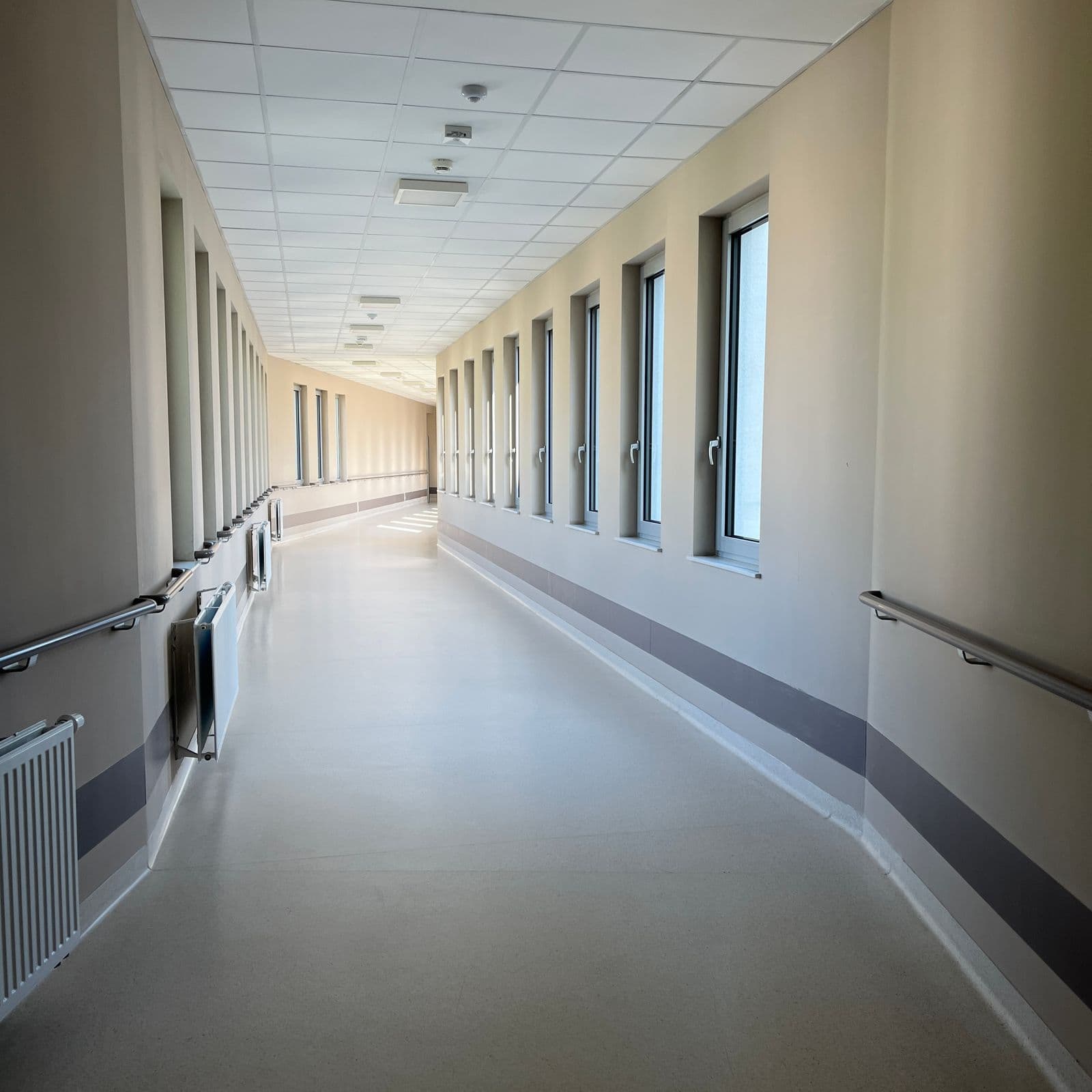 Bright modern hospital corridor with large windows