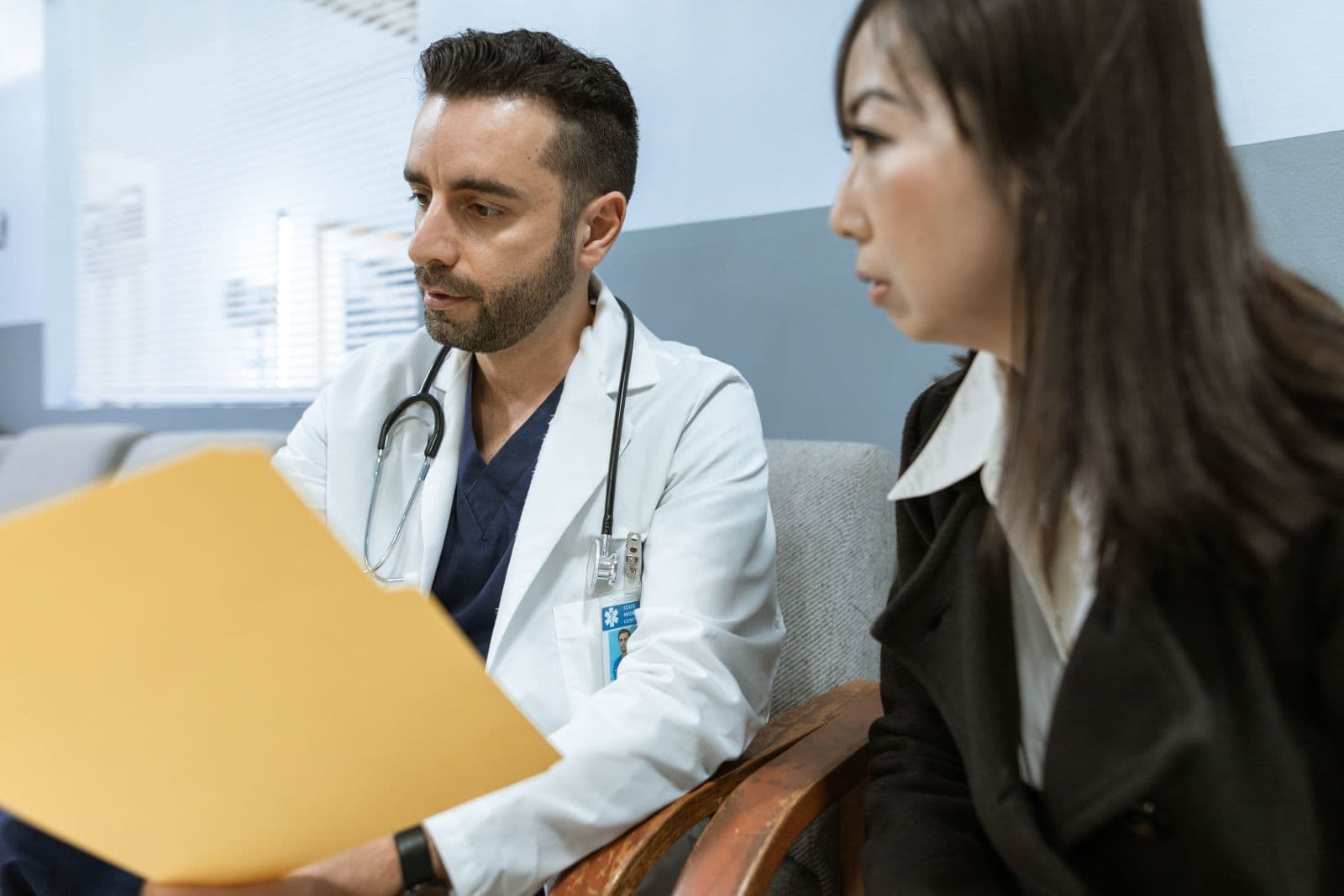 Doctor and patient reviewing a file together