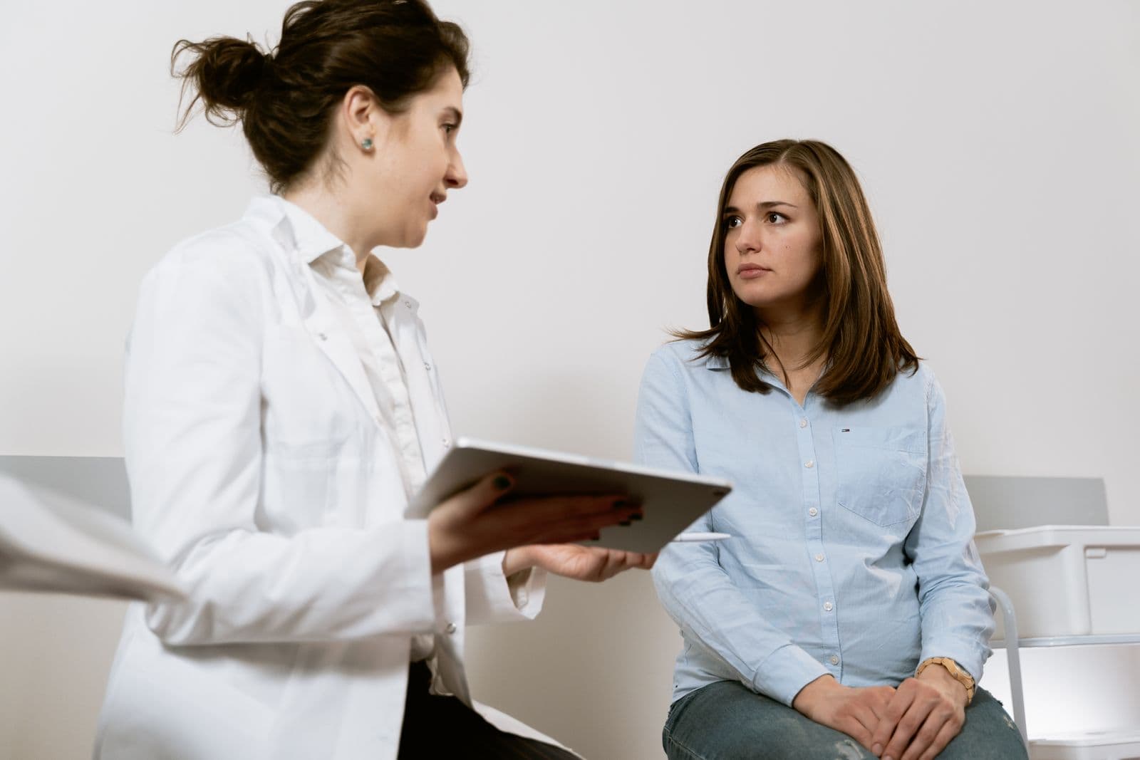 Doctor showing a patient information on a tablet
